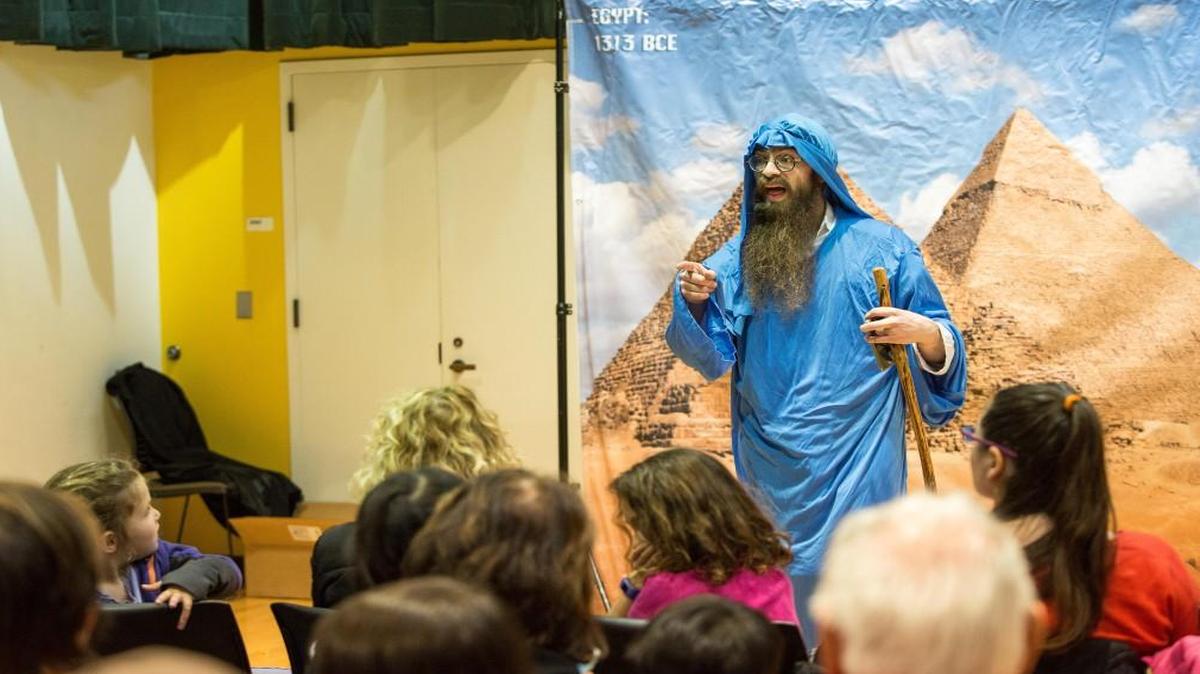 Rabbi Levi Raskin, dresed as Moses, performs for an audience of children at the Jewish Cultural Festival in Cary, N.C. on Sunday, Mar. 19, 2017.