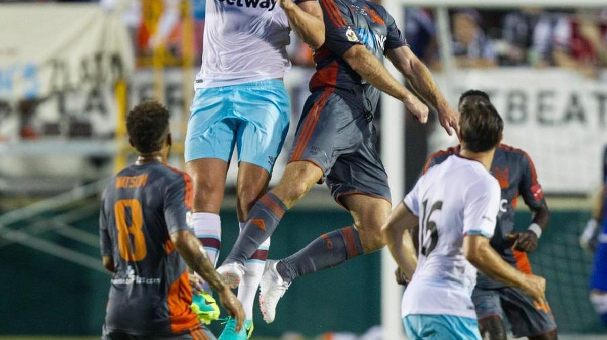 West Ham's Andy Carroll (9) and Carolina RailHawk's Simon Mensing (27) battle for a header during the first half between the Carolina RailHawks and West Ham United at the WakeMed Soccer Park in Cary, N.C., July 12, 2016.