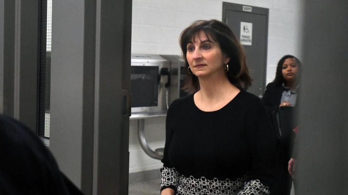 Former Wake County Register of Deeds Laura Riddick walks into the booking area at the Wake County Detention Center after she turned herself in to law enforcement officers in Raleigh, N.C. Wednesday, Dec. 13, 2017. Riddick has been accused of embezzling more than $900,000 from the office she presided over for two decades.