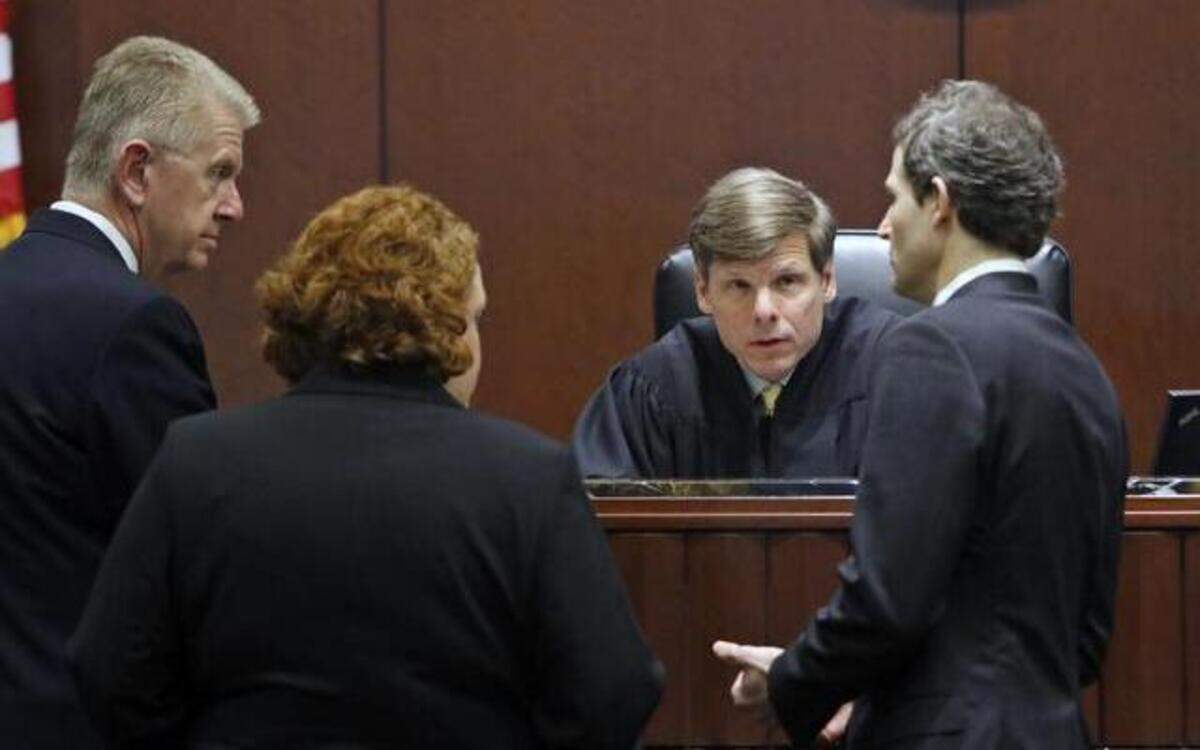 
L to R: Broyhill defense attorneys Joseph Arbour, Caroline Elliott, Judge Paul Ridgeway and Wake prosecutor Doug Faucette confer at the Judge's bench Wednesday morning, March 11, 2015, over a juror issue which has put off the morning testimony until settled. One juror reported another juror has said they had discussed the case with their spouse.
