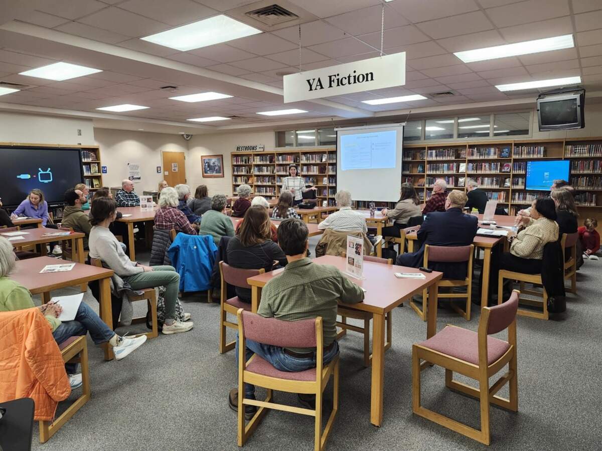 Hannah McKenzie speaks to community members about the future of the Athens Drive Community Library in Raleigh in 2025.
