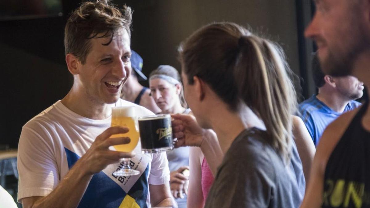 Alex Orocz, left, and Liz Tracy toast beers at Trophy Brewing & Taproom in Raleigh on July 9, 2017. The Triangle has seen an increase in local breweries.