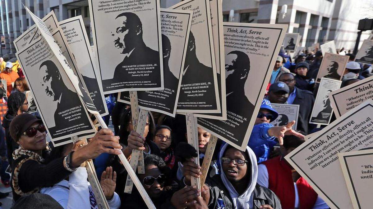 Signs are passed out to more than 1,000 community members prior to the beginning of the Martin Luther King Jr. 40 Days of Peace March in downtown Raleigh, N.C. on Monday, January 19, 2015.