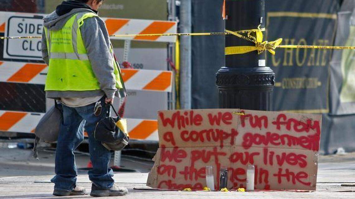 
Jose Oscar of Juba Aluminum Products Company of Concord, NC paused Tuesday morning, March 24, 2015 to read the small memorial for the three men killed the day before at the Charter Square building when a scaffolding collapsed while dismantling it in downtown Raleigh. Oscar, from Durham, NC showed up for work, but he and other coworkers for Juba went home after discovering the job site was closed for the day.
