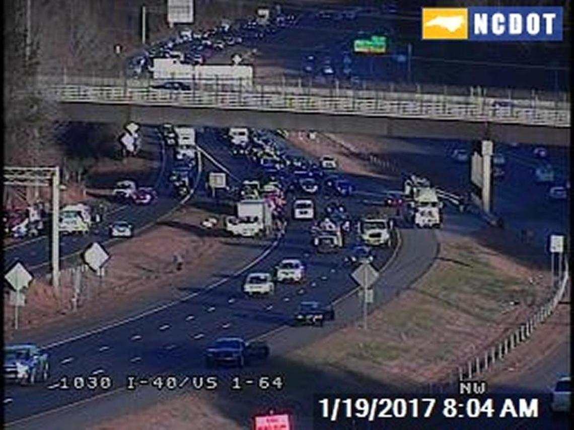 Drivers paused along the shoulders of Interstate 40 near the U.S. 1 interchange in Raleigh in 2017 after seeing cash flying from an armored car on the highway.