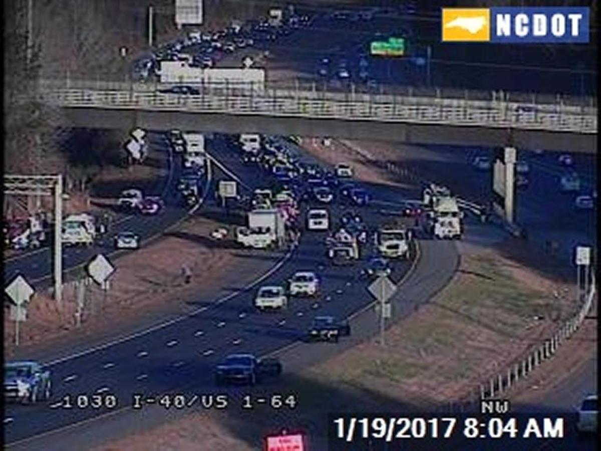 Drivers paused along the shoulders of Interstate 40 near the U.S. 1 interchange in Raleigh in 2017 after seeing cash flying from an armored car on the highway.