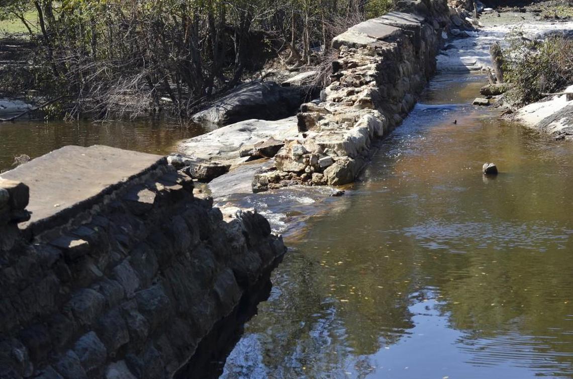 Water spills over the central section of the damaged Little River dam in Zebulon, N.C. Tuesday, Oct. 25, 2016. The dam crumbled during Hurricane Matthew.