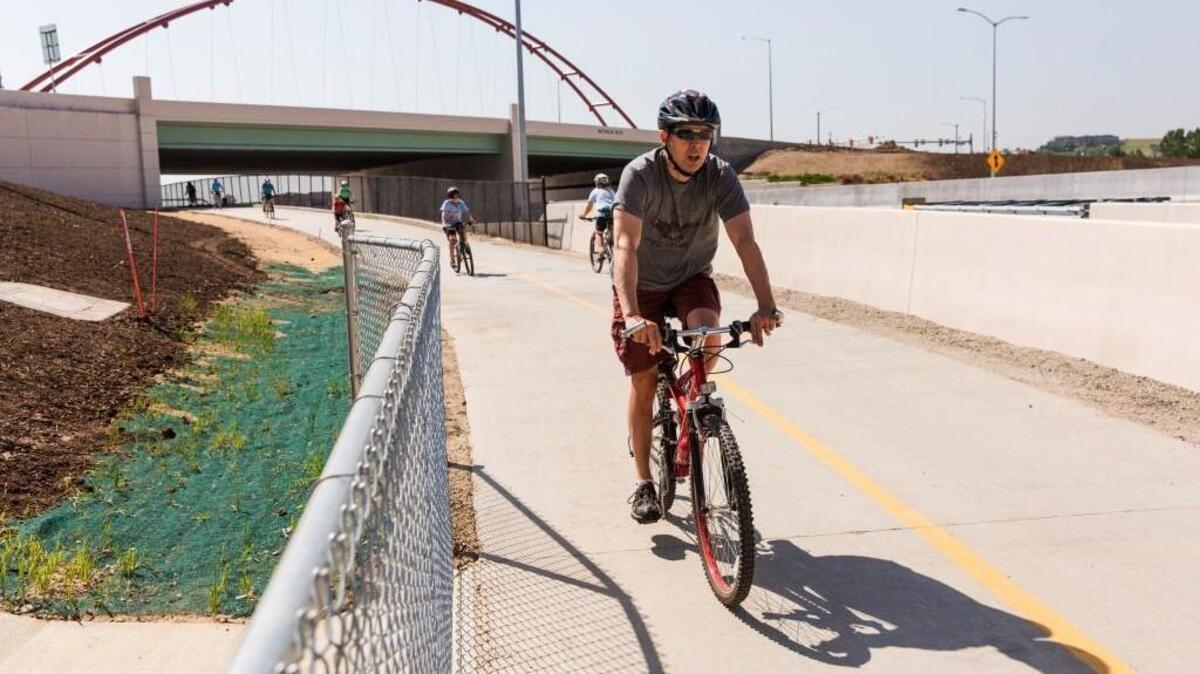 Cyclists pedal along the US 36 Bikeway in June 2016. The 18-mile paved trail, a commuter highway for bicyclists, runs along US 36 between Boulder and Denver, Colorado.