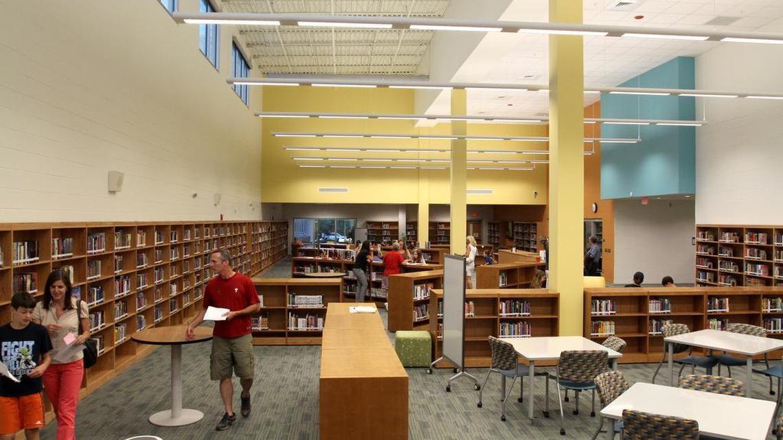 Parents and students check out the media center at Pine Hollow Middle School on Thursday. The new school opened Monday.