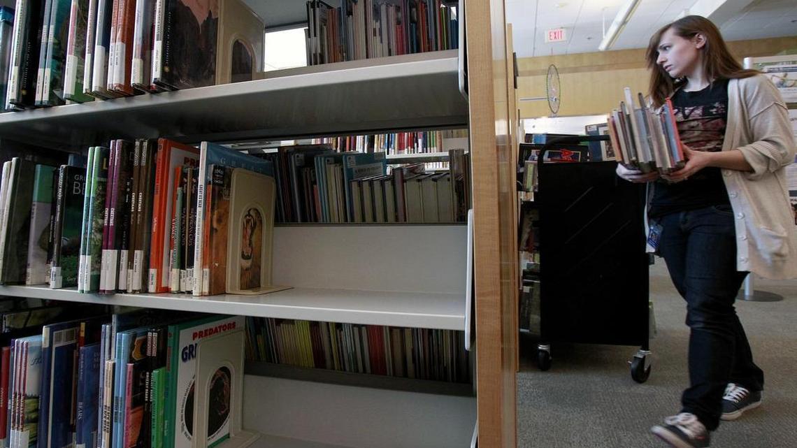 
A library staffer reshelves books at Cameron Village Regional Library in 2013. Wake County recently changed its policies to allow religious and political groups to use county library rooms after it was sued by a Christian group that was denied space at the Cameron Village library. 

