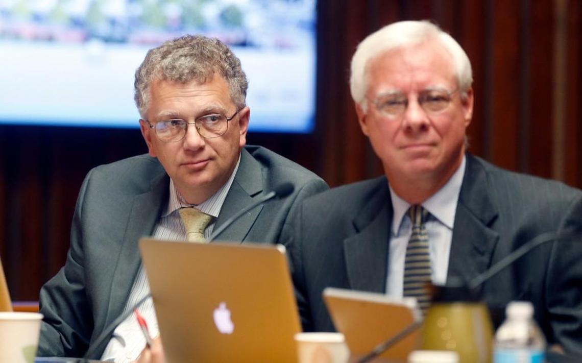 Raleigh City Council members David Cox, left, and Russ Stephenson listen during a council meeting in the municipal building in 2016