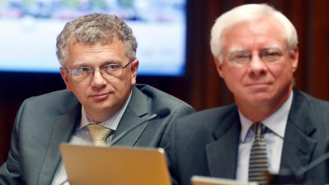 Raleigh City Council members David Cox, left, and Russ Stephenson listen during a council meeting in the municipal building in 2016