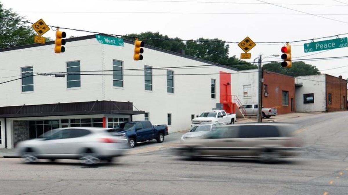 Traffic passes through the intersection of Peace and West streets in downtown Raleigh in this file photo from April 2016.