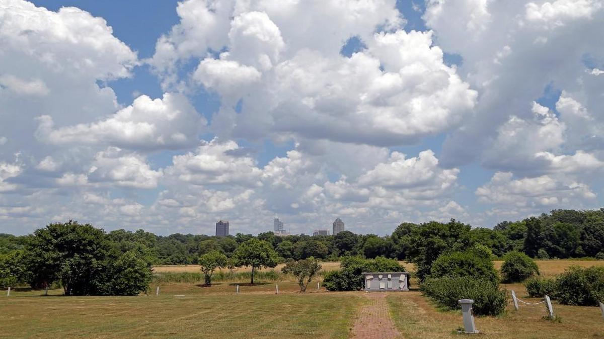 Under a canopy of puffy clouds, the city skyline is seen from the Dorothea Dix Hospital cemetery on the Dix campus in Raleigh on June 1, 2015. After years of haggling between city and state leaders about the city’s acquiring the property, now city planners are addressing how to specifically develop the land.