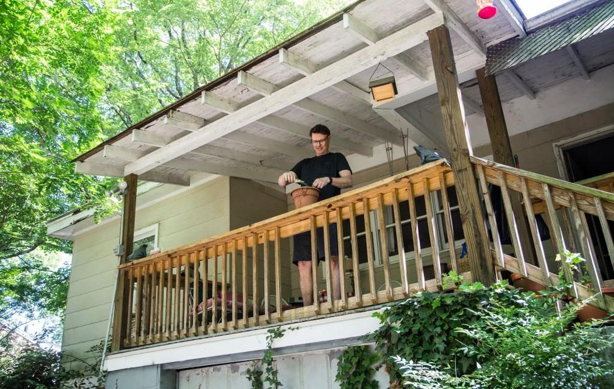Thomas Attride tends to plants Tuesday, May 2, 2017 at his home in Raleigh’s Oberlin Village neighborhood. The area was settled in the 1800s by freed slaves.