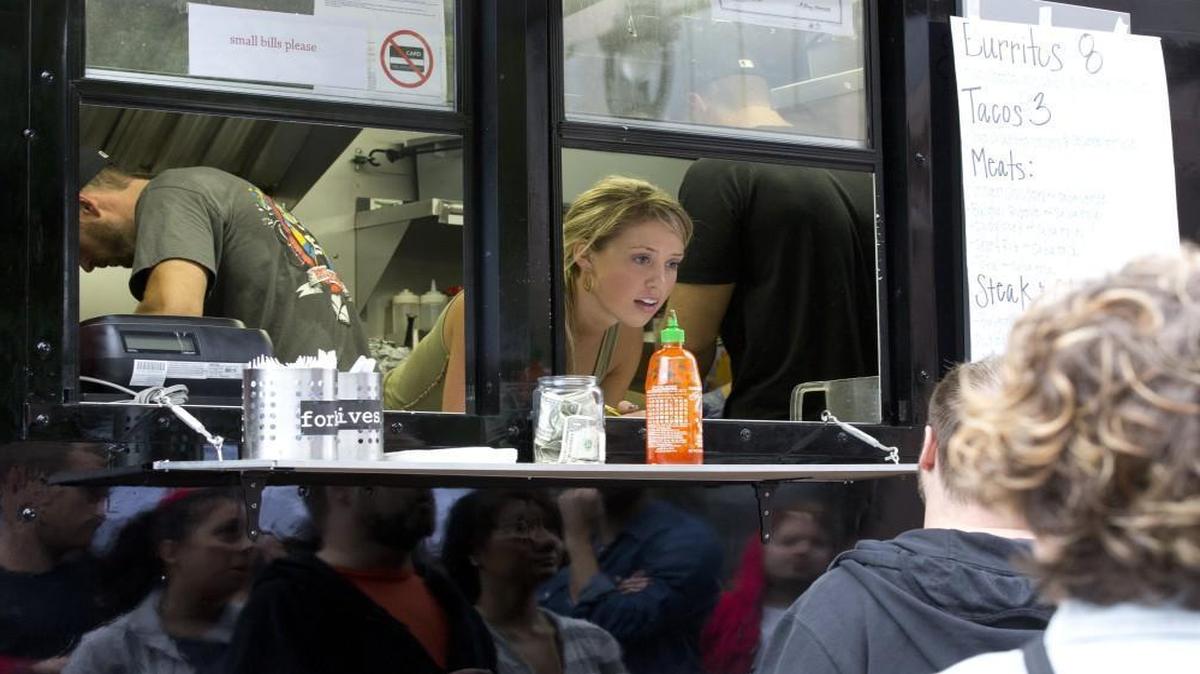 Caroline Williams takes order from the Urban Street Grill Korean BBQ food truck during the Food Truck Rodeo on October 11, 2013, in downtown Raleigh.