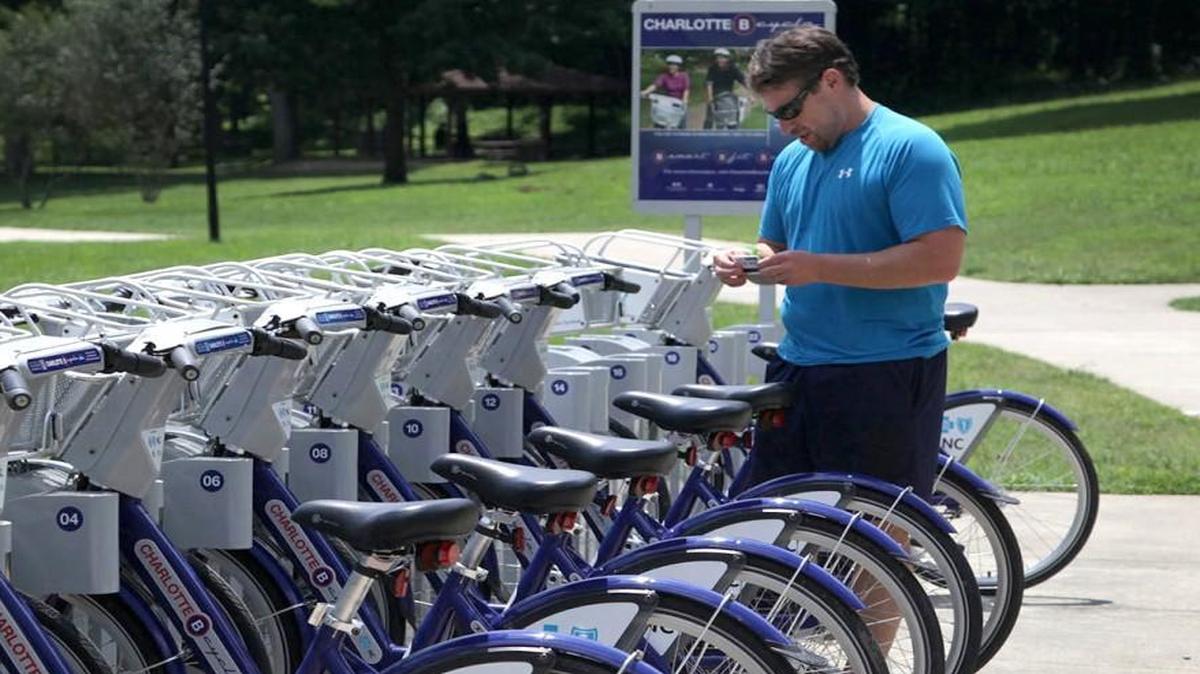 Andy Mock prepares to get a bike from the Charlotte B-cycle station at Freedom Park on Monday, July 29, 2013. "These bikes saved me. I used to have to take my bike to work, which was kind of a hassle," says Mock. He purchased a year-long membership so he can use the bikes whenever he needs them. Charlotte B-cycle is a bike sharing system with 200 bicycles and 20 stations spread out around Charlotte.