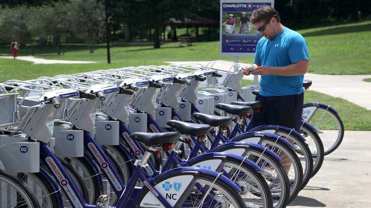 Andy Mock prepares to get a bike from the Charlotte B-cycle station at Freedom Park on Monday, July 29, 2013. "These bikes saved me. I used to have to take my bike to work, which was kind of a hassle," says Mock. He purchased a year-long membership so he can use the bikes whenever he needs them. Charlotte B-cycle is a bike sharing system with 200 bicycles and 20 stations spread out around Charlotte.