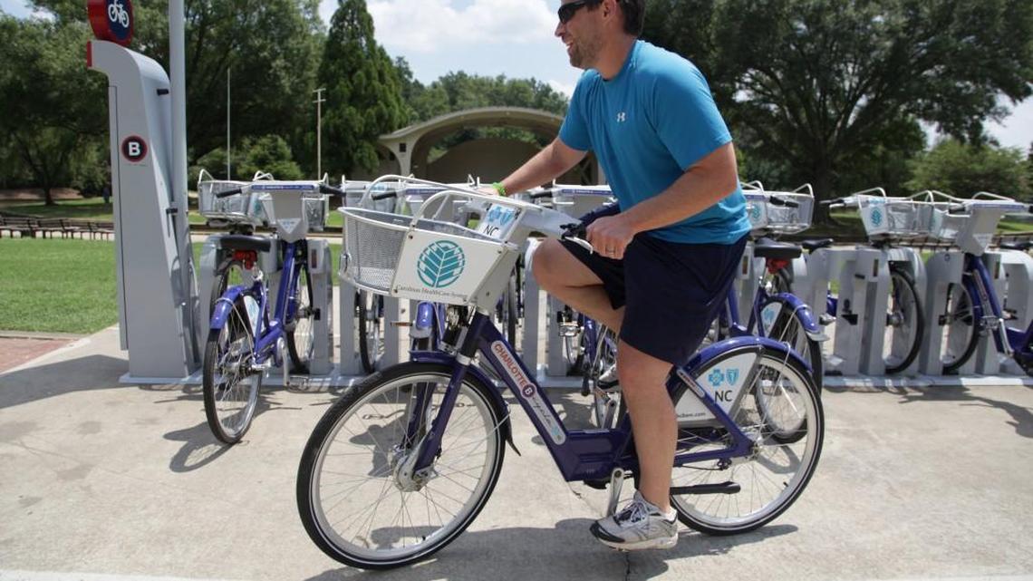Andy Mock takes a bike for a ride from the Charlotte B-cycle station at Freedom Park on Monday, July 29, 2013. "These bikes saved me. I used to have to take my bike to work, which was kind of a hassle," says Mock. He purchased a year-long membership so he can use the bikes whenever he needs them. Charlotte B-cycle is a bike sharing system with 200 bicycles and 20 stations spread out around Charlotte. It is celebrating its one year anniversary this week.