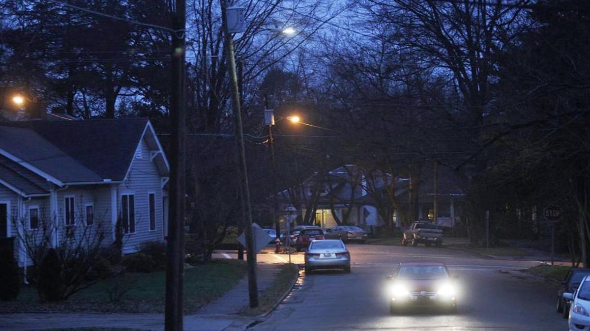 A newly installed LED street light, top, shines in front of a conventional sodium-vapor street light on Lenoir Street in the historic neighborhood of Boylan Heights. Raleigh is trying to save money and be more eco-friendly by installing LED bulbs in streetlights all over the city. But the city's Historic Development Commission says they're too bright.