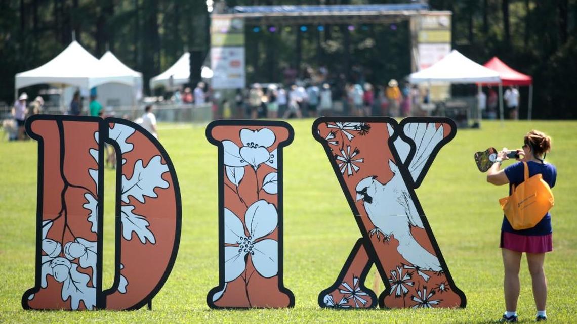 A woman takes a closer photo of giant DIX letters in the middle of the Dorothea Dix Park grounds Saturday, July 23, 2016, for the first Destination Dix community festival.