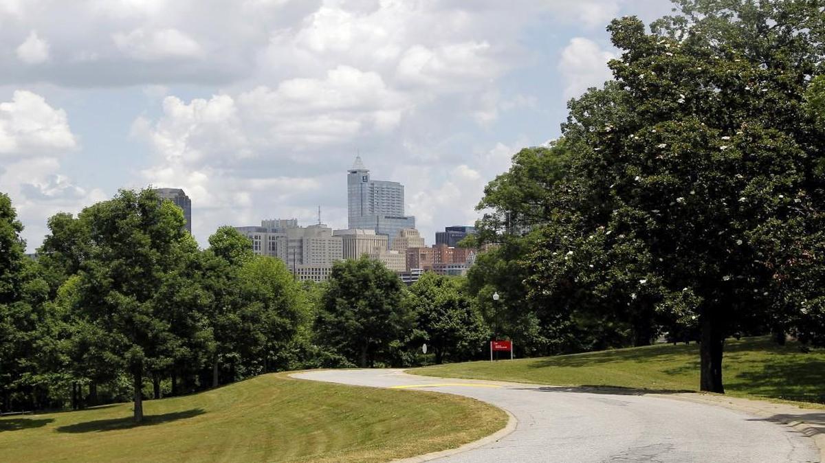 Under a canopy of puffy clouds, the city skyline is seen from the Dorothea Dix campus in Raleigh on June 1, 2015.