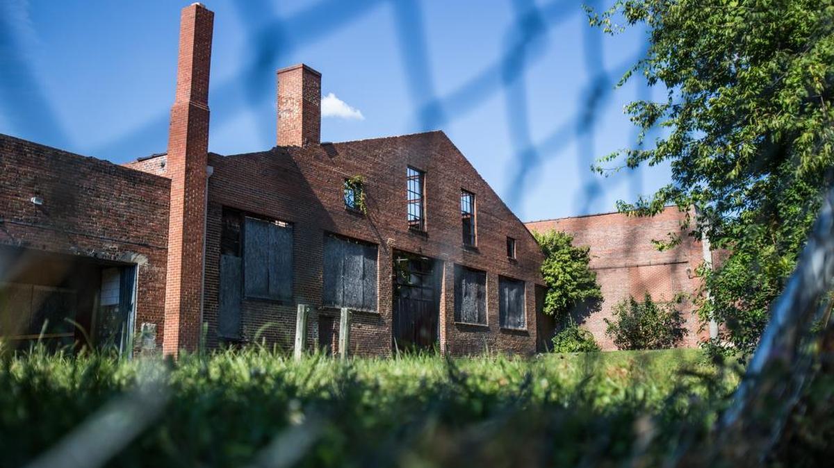 
Stone's Warehouse sits abandoned in downtown Raleigh on Sunday, August 2, 2015. Transfer Company LLC hopes to buy Stone's Warehouse in downtown Raleigh from the City of Raleigh to transform the 2.6 acre lot into a new hub for local cafes, markets and businesses. On Tuesday, August 4, 2015, the Raleigh City Council plans to hold a meeting to hear the public's opinion on the $2.02 million sale.
