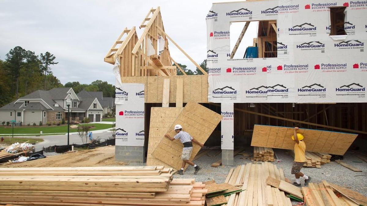 Alejandro Garcia, left, and fellow builders construct a home on Massey Branch Drive in Rolesville in October 2015. The Raleigh-Cary metropolitan area was the fastest growing in the state in the year ending last June 30, according to the U.S. Census Bureau.