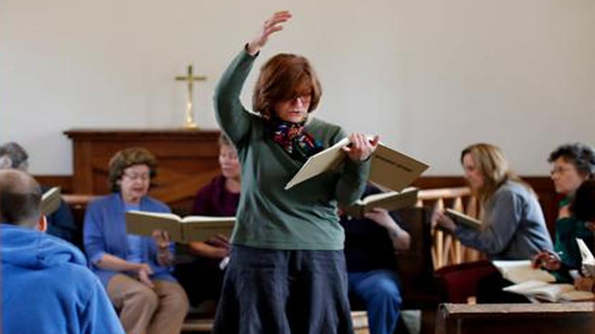 
Lynda Hambourger leads the group during a folk music concert performed by the Triangle Shape Note Singers at St. Mark’s Chapel in Mordecai Historic Park on Sunday.
