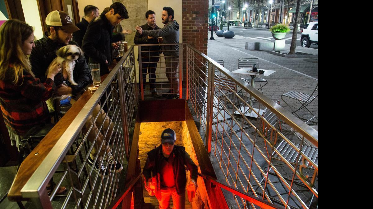 
Patrons congregate outside Foundation cocktail bar late Wednesday night, January 22, 2015 on Fayetteville Street in downtown Raleigh. In June 2015, the city of Raleigh is considering a change to the way restaurants and bars use public sidewalks.
