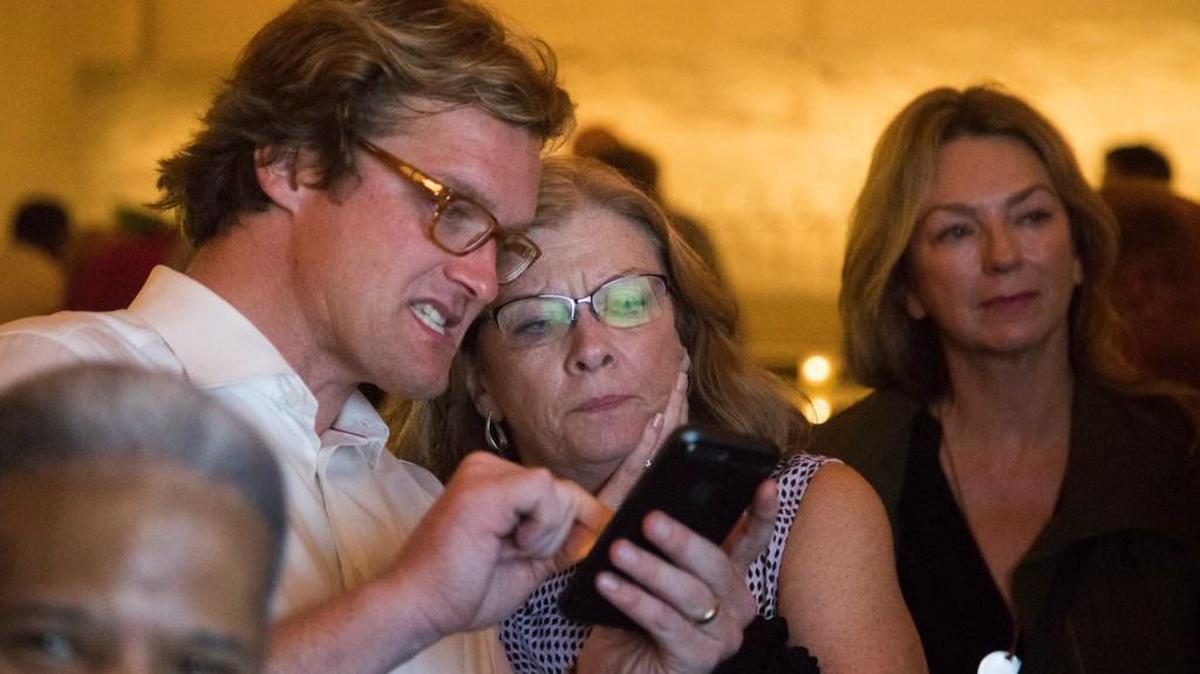 Raleigh city council member Bonner Gaylord and mayor Nancy McFarlane look at election returns on a cell phone Tuesday evening, Oct. 10, 2017 at Brewery Bhavana in downtown Raleigh.