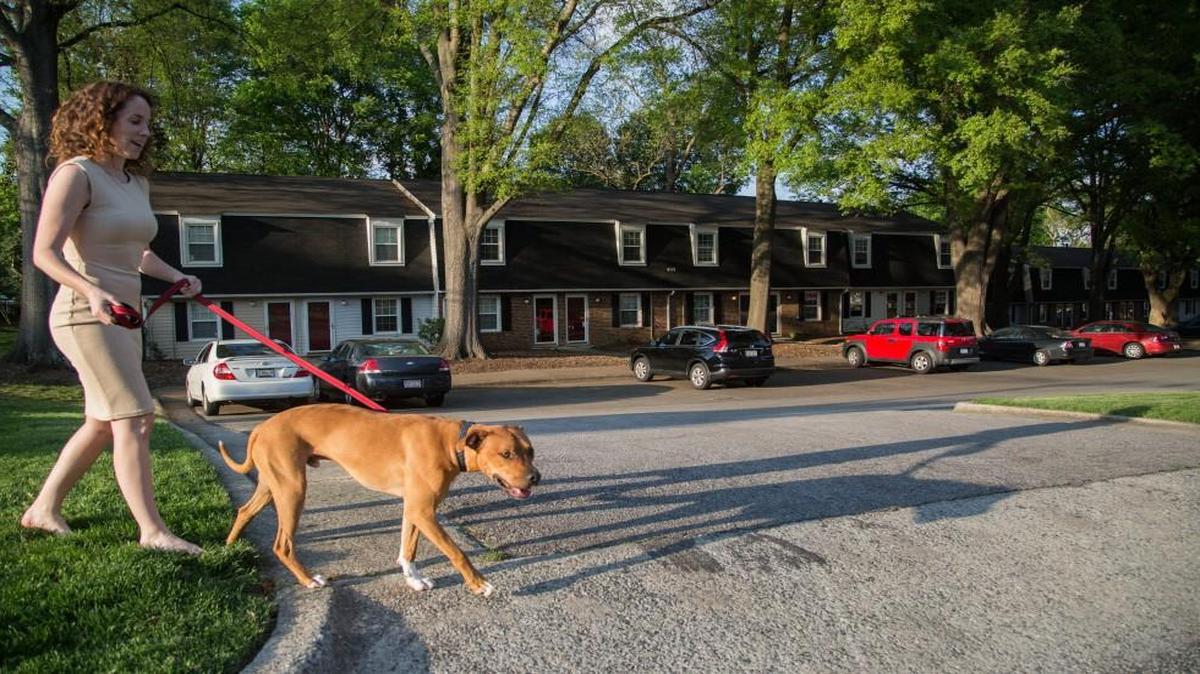 Morgan Davis walks her dog, Calvin, on April 21, 2015, at Clover Lane Townhomes in Raleigh. The amount of affordable housing in and around downtown Raleigh and elsewhere in Wake County is declining as real estate values rise.