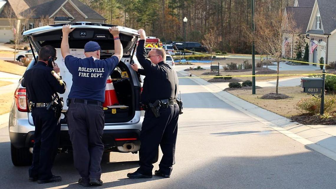 Members of the Rolesville Police Department and Rolesville Fire Department gather near the home at 6205 Roles Saddle Drive in Rolesville on Friday, Dec. 11, 2015. A fire Friday morning in the home killed a woman and a 3-year-old child. Another 3-year-old child was taken to the burn center at UNC Hospitals in Chapel Hill. Police are investigating the fire as “suspicious.”
