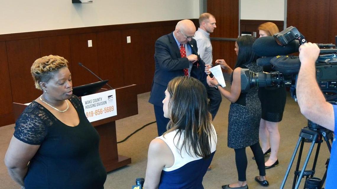 Wake County commissioners and residents of Forest Hills Apartments speak during a press conference in Raleigh on May 19.