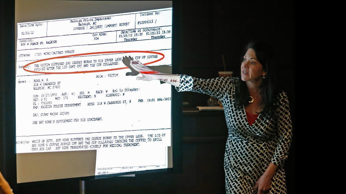 
Starbucks attorney Tricia Derr shows the jury what she says are inconsistencies in Raleigh PD officer Matthew Kohr's police report from 2012 during closing arguments in Wake Superior Court Friday, May 8, 2015. 
