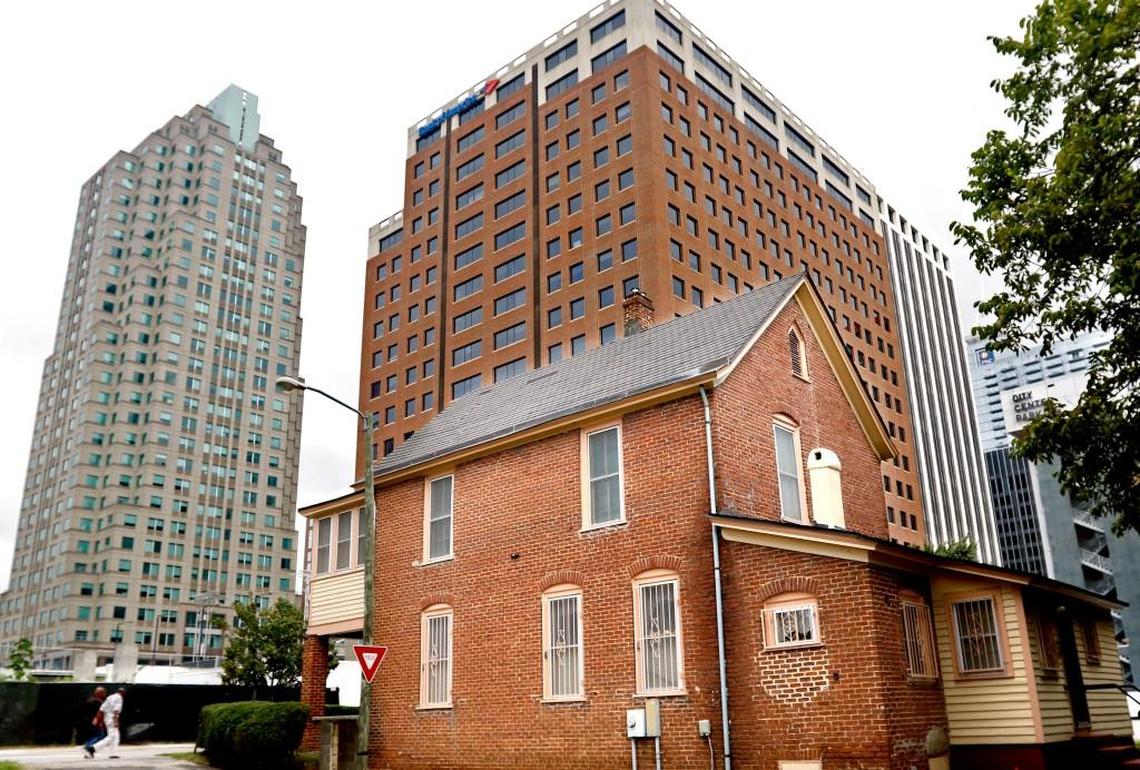 The Manassa T. Pope House Museum, foreground, at 511 South Wilmington Street in downtown Raleigh is dwarfed by newer skyscrapers Saturday, September 5, 2015. The Pope House Museum became a living history event Saturday commemorating the 70th anniversary of World War II as celebrated by Raleigh’s African-American community.