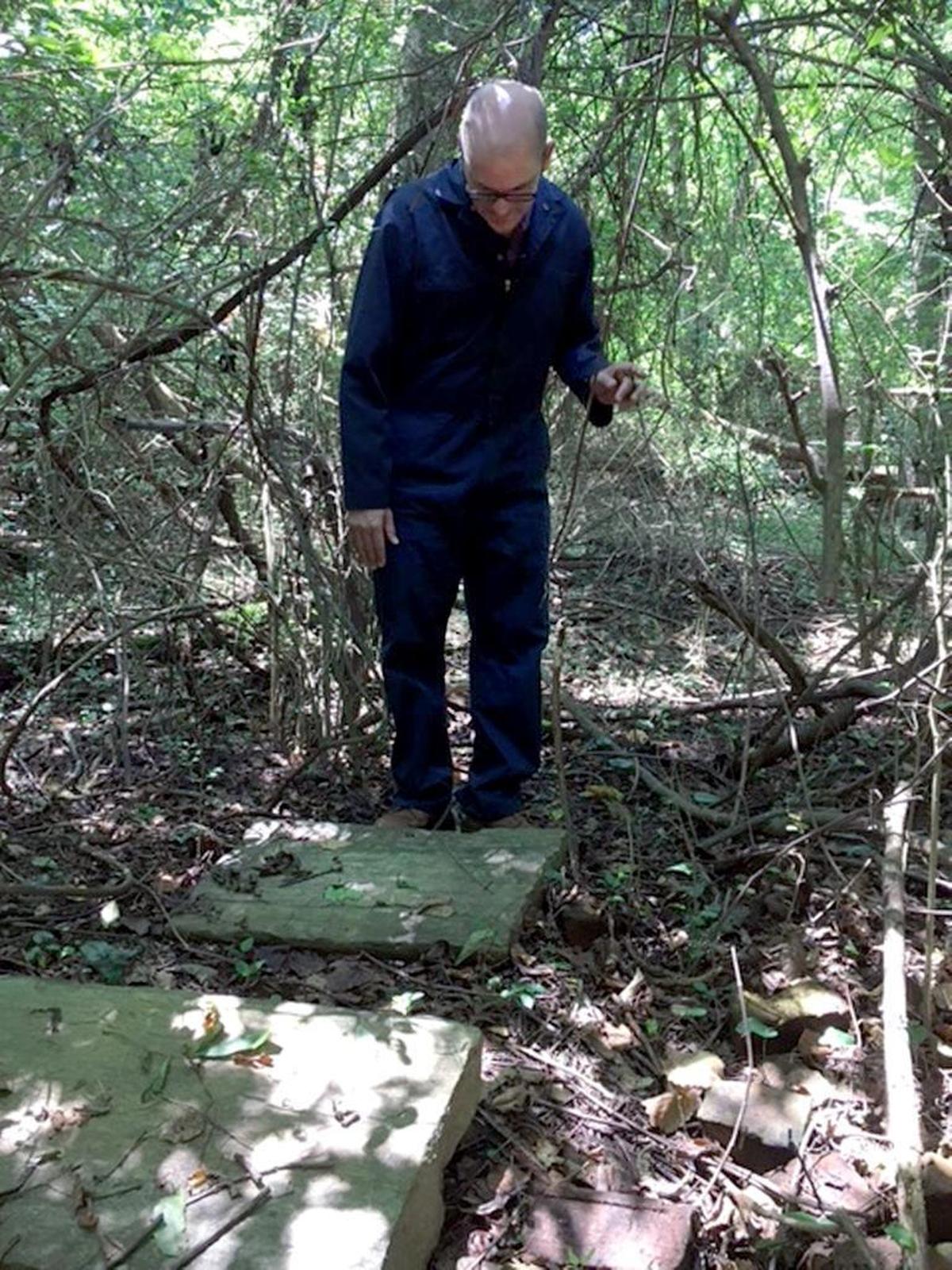 Mark Turner inspects stones and concrete slabs at the site of Isaac Hunter’s tavern.