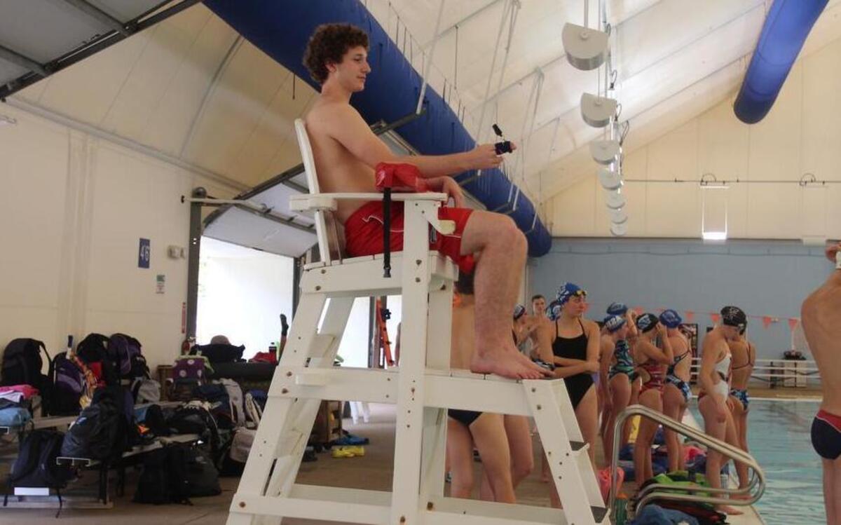 
Lifeguard Sam Rennert watches the pool at Optimist Park in Raleigh on Thursday during a swim team practice. A lifeguard shortage is forcing the city to cut pool hours.
