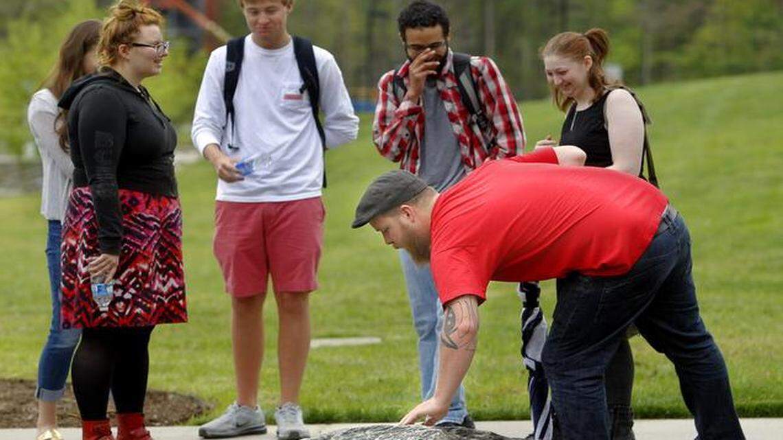 
Faculty, administrators and geology students, like Dominic Martino, front, gathered in the quad at Wake Tech Community College's Northern Wake Campus in Raleigh, N.C. on Tuesday, April 14, 2015 for the dedication of the Mountains to the Sea Outdoor Geology Lab Pathway. It's a geological display of 14 boulders, from 11 quarry sites across the state, and it took three years to complete. 

