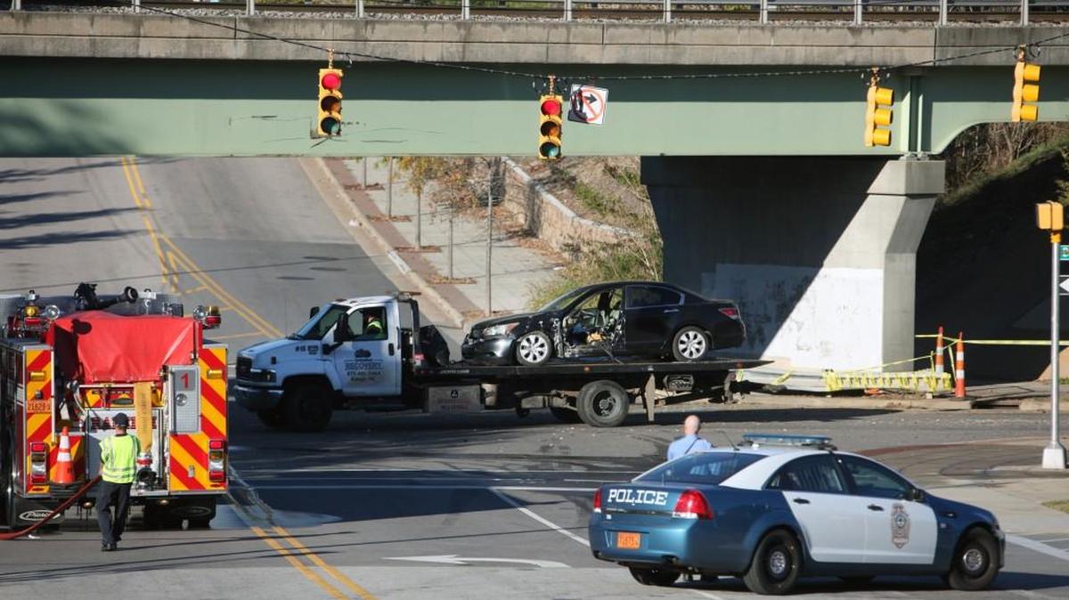 Raleigh police and fire personnel stand by as the vehicle involved in a fatal crash is hauled away from the intersection of South Dawson and South Lenoir streets in downtown Raleigh in 2016.