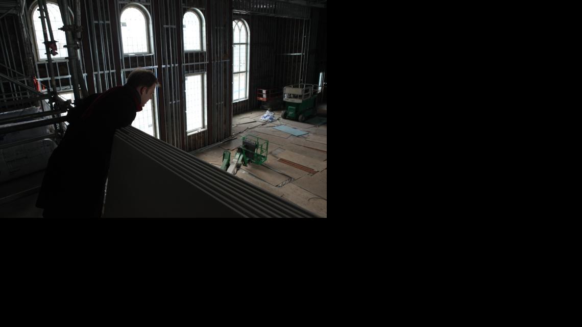 
The Rev. John Yates III, rector of Holy Trinity Anglican Church, leans out for a glimpse of construction on the church’s new  building, the first church built in downtown Raleigh in recent history.
