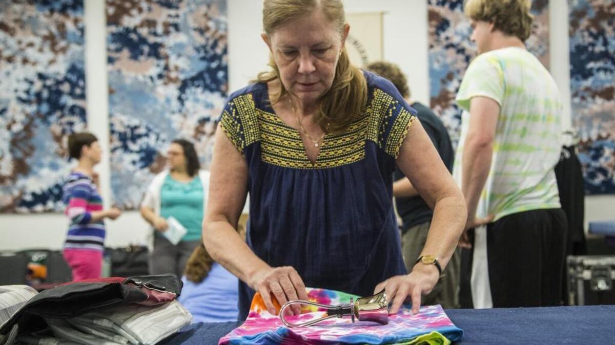 Ruth Brown, a member of The Raleigh Ringers carefully packs bells Thursday for the group’s trip to Europe.