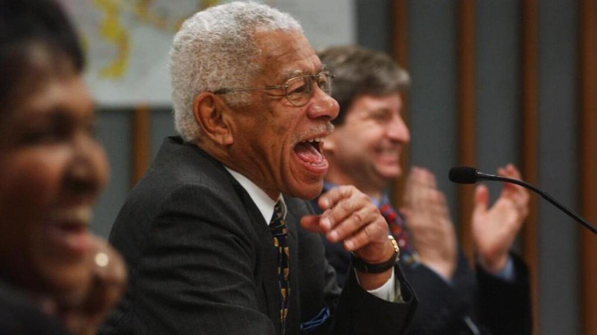 Harold Webb, center, laughs at a remark made by Vernon Malone after Webb’s swearing in as a member of the Wake County Board of Commissioners in 2003. Webb died Thursday, Dec. 14, 2017.