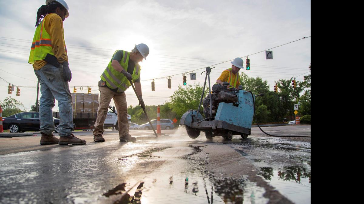 
Construction workers from left, BeQuanta Malone, Chris Handy and Dean Harviel cut asphalt on the I-40 westbound ramp to northbound South Saunders Street in Raleigh Wednesday, May 6, 2015 as NCDOT speeds up work on rebuilding the 8-mile I-40 stretch of the southern Beltline. The off ramp for westbound I-40 to southbound Saunders closes this weekend, followed in a week or so by the eastbound I-40 to northbound Saunders. Exiting drivers will be crammed into the remaining two ramps from now until sometime in 2016. 
