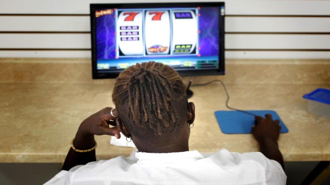 
A 2010 file photo shows a woman playing a sweepstakes game at a sweepstakes parlor in Raleigh.
