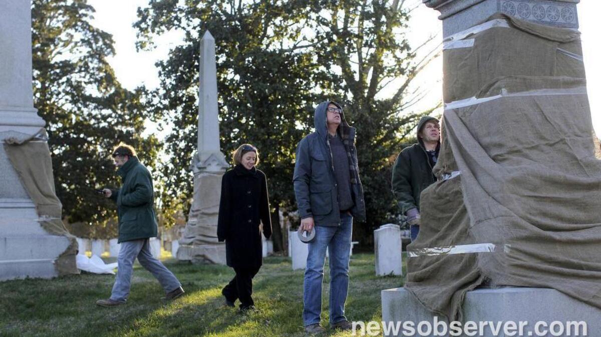 From left, Historic Oakwood Cemetery employees Sam Smith and Robin Simonton show Ron Bartholomew and Michael Batts of Wake Monument vandalized grave markers and monuments in the Confederate section of Historic Oakwood Cemetery Tuesday, January 5, 2016 in Raleigh, N.C.