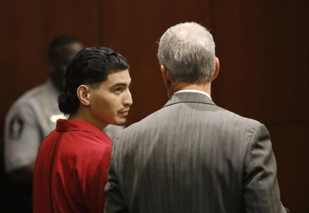 Jonathan Santillan, then 18, looks to his defense attorney, Jeff Cutler, after he was sentenced by Judge Paul Gessner to life without parole in Wake County Superior Court on Sept. 1, 2015. Santillan was convicted in the 2013 murders of Jose Samuel Flores Mendoza and his wife, Maria Saravia Mendoza.