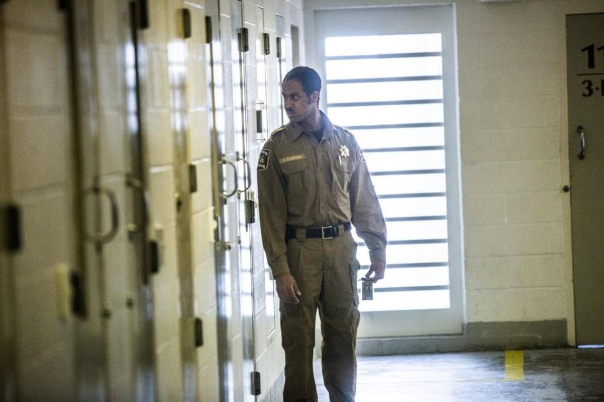 A corrections officer performs a cell check at the Durham County Detention Facility.