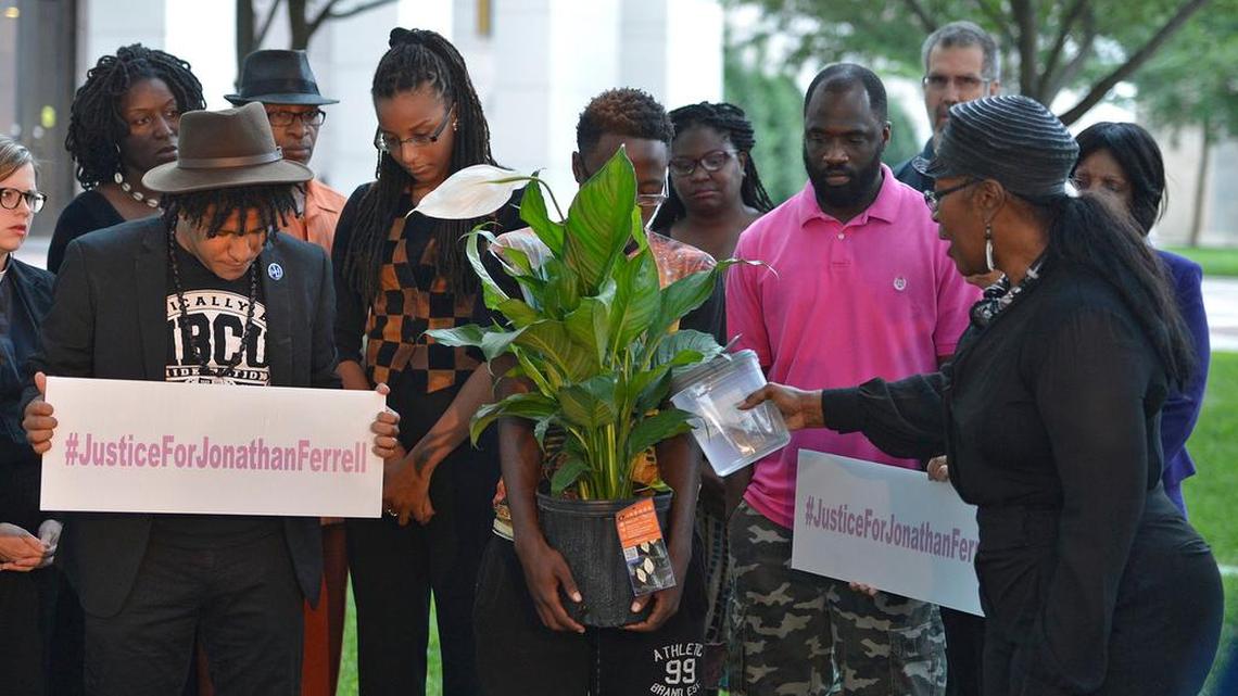 
About 30 people participated in a memorial service outside the Mecklenburg County Courthouse early Monday morning, August 10, 2015, to pray for Jonathan Ferrell and other black people killed by police recently. 
