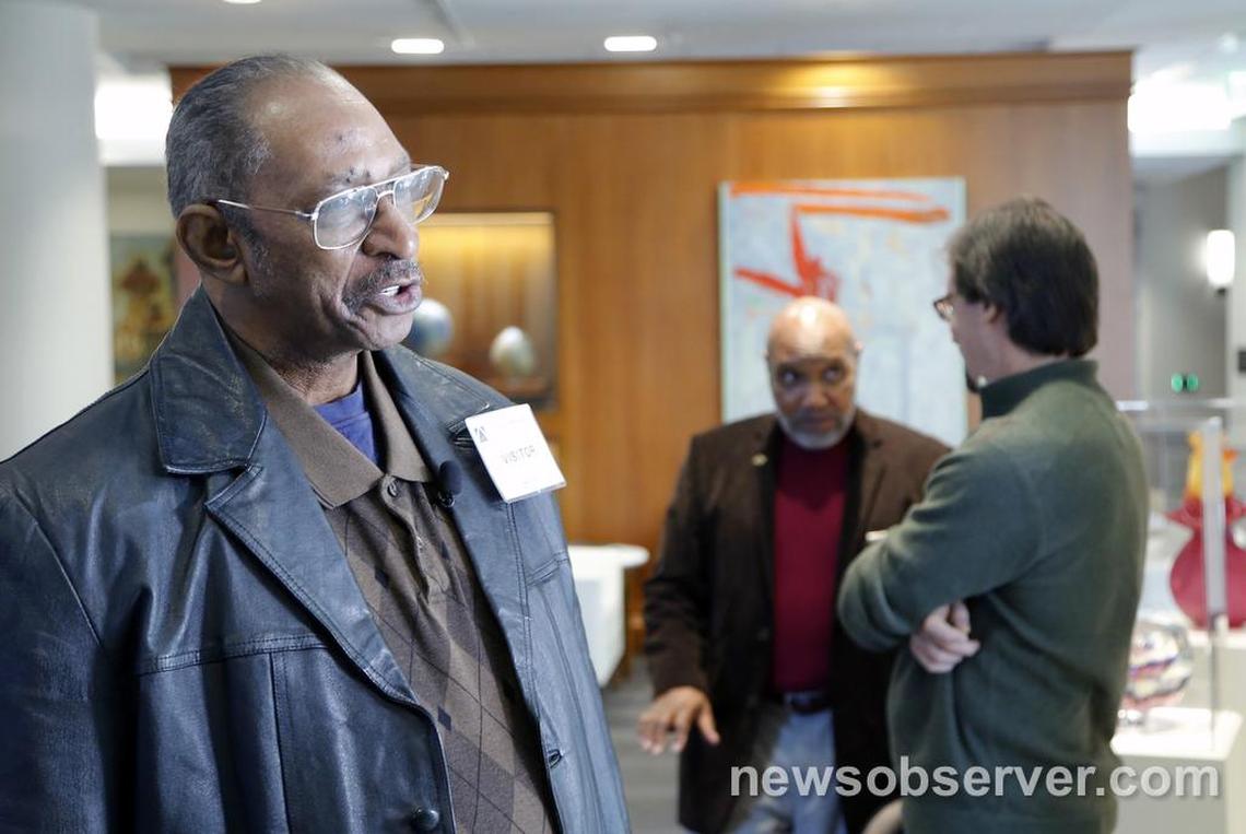 Willie Grimes, left, talks to the media while Larry Lamb, center, and Greg Taylor talk together during a break as N.C. Center for Actual Innocence lawyer Christine Mumma goes before N.C. State Bar in Raleigh, NC for a disciplinary hearing on Monday, Jan. 11, 2015. All were exonerated of felony charges largely due to the work of Mumma and her commission.